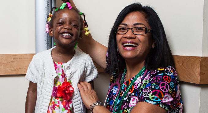 Child getting her height measured at a check up